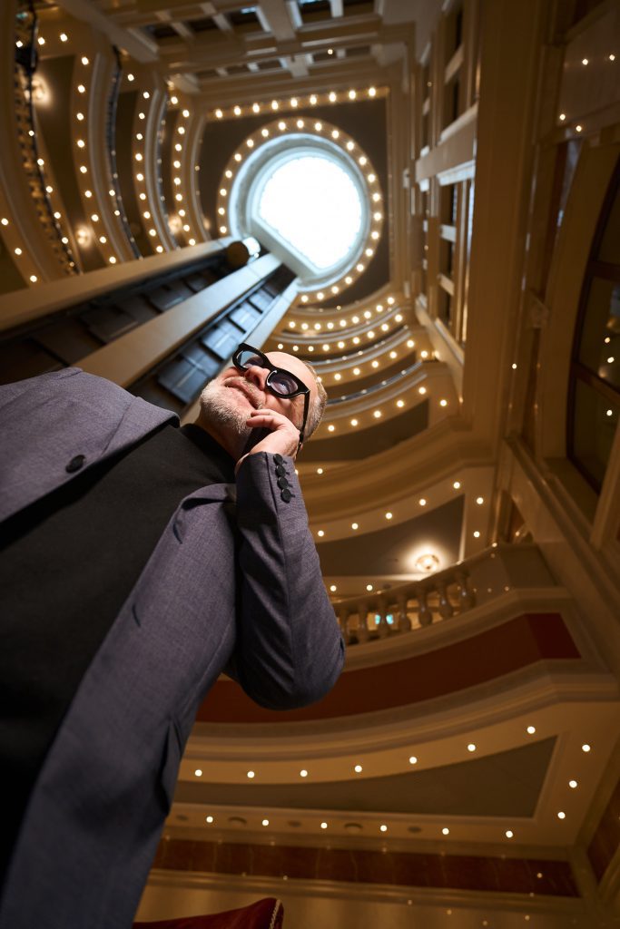business elderly male talking on the phone in hotel lobby