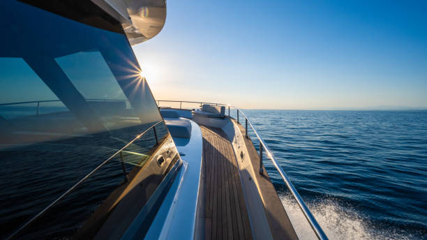 luxury yacht moving in sea against blue sky.